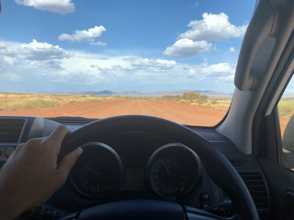 youg-millenial-driving-a-car-on-a-dirt-road-in-aus-WR2R3QN.jpg